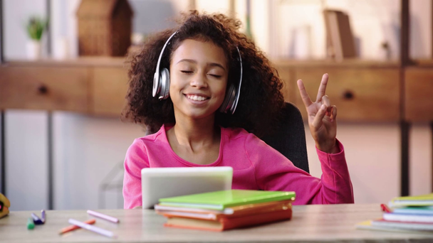 Χαρούμενη αφροαμερικανική παιδί ακούγοντας μουσική και δείχνοντας σημάδι ειρήνης - Πλάνα, βίντεο