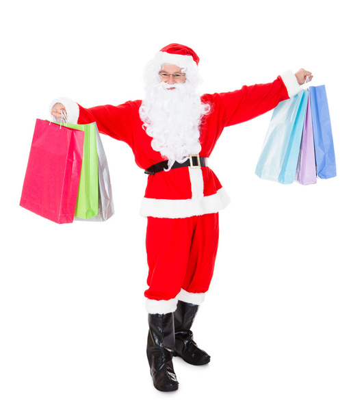 Portrait of santa holding shopping bag - 写真・画像