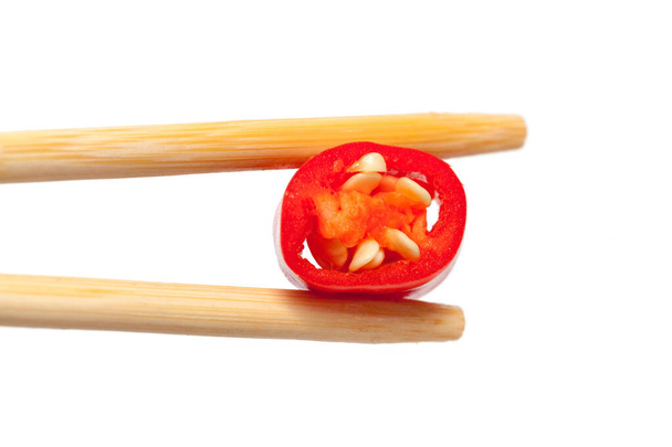 close up of chopstick and chicken breast with sauce - Valokuva, kuva