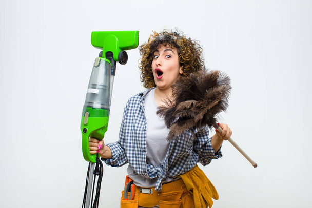 housekeeper pretty woman with a vaccum cleaner - Foto, imagen