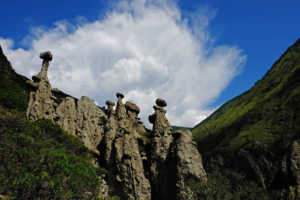 Stone mushrooms behind the cloud. Natural phenomenon in Altai mountains. Russia. - Фото, изображение