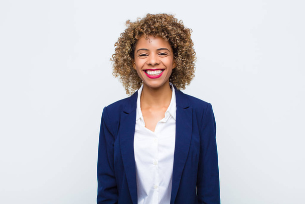 young woman african american smiling cheerfully and casually with a positive, happy, confident and relaxed expression against flat wall - Fotografie, Obrázek