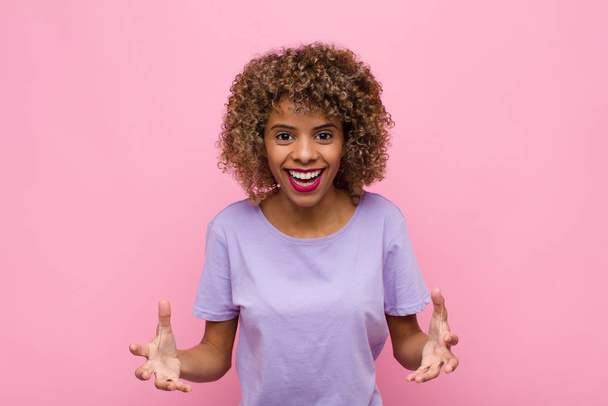 young african american woman feeling happy, astonished, lucky and surprised, like saying omg seriously? Unbelievable against pink wall - Foto, Imagem