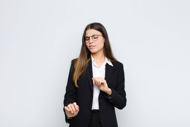 young businesswoman feeling disgusted and nauseous, backing away from something nasty, smelly or stinky, saying yuck against white wall - Fotoğraf, Görsel