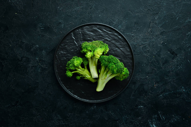 Fresh green broccoli on dark old background. Top view. Free space for your text. - Zdjęcie, obraz