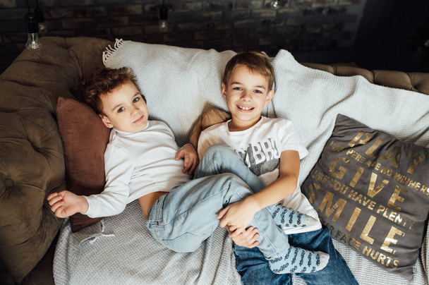 Two funny boys play together. Cute happy brothers smiling and having fun - Foto, afbeelding