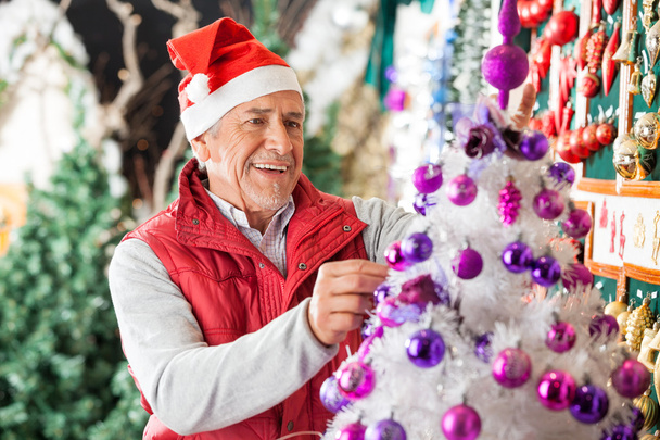 Happy Male Owner Decorating Christmas Tree - Foto, Bild