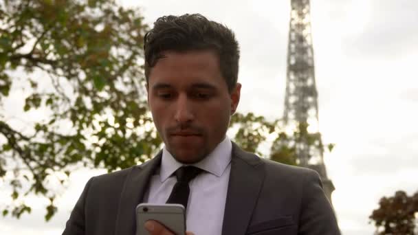 Man in a suit typing messages on a mobile phone - Video