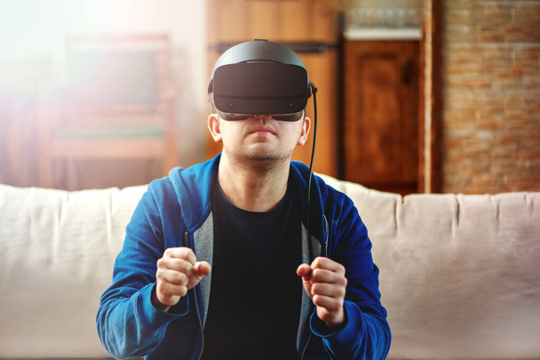 Young man wearing VR glasses. - Foto, afbeelding