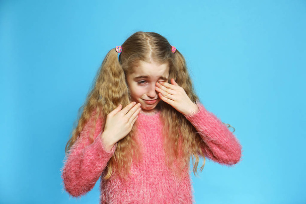 The little blond-haired girl Isolated cries, wiping her face with her hands.  - Photo, Image