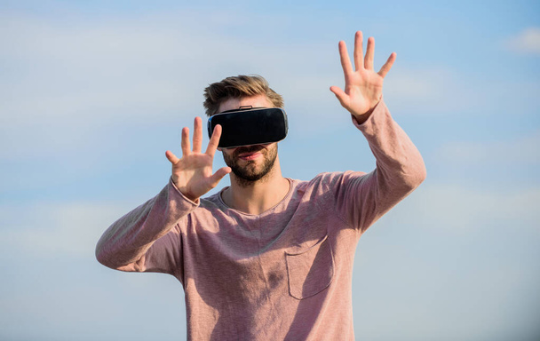 Man explore VR sky background. VR technology and future. VR communication. Exciting impressions. Gaming and entertainment. Interaction with digital surface. Gesture control. 3d visualization - Foto, afbeelding