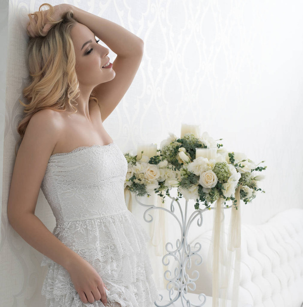 Sexy blonde wearing lace dress in luxurious hotel - Фото, зображення