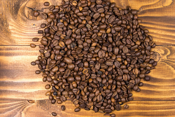Roasted coffee beans on wooden background - Photo, Image