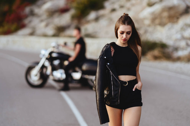Portrait of beautiful young couple on a motorcycle. - 写真・画像