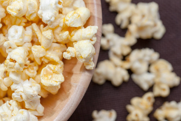 close up of popcorn in wooden bowl - Фото, изображение
