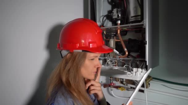 Professional worker inspecting new gas heating system at private house - Footage, Video