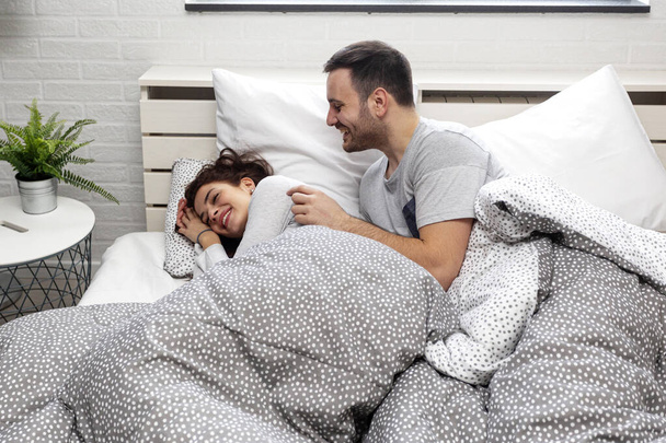 Young couple sleeping in bed in bedroom - Photo, Image
