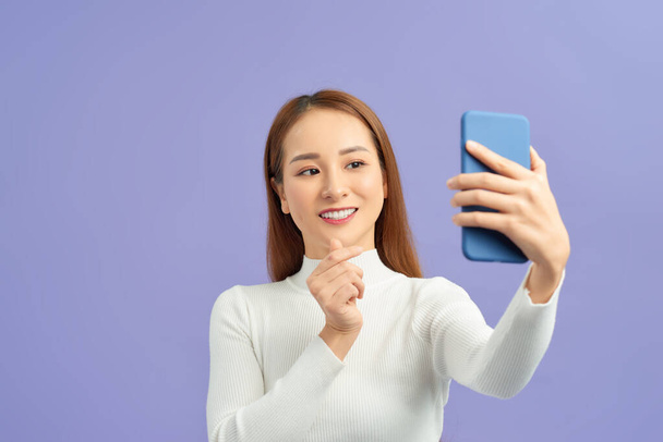 Selfie time. Joyful young women making selfie by her smart phone - Foto, Bild