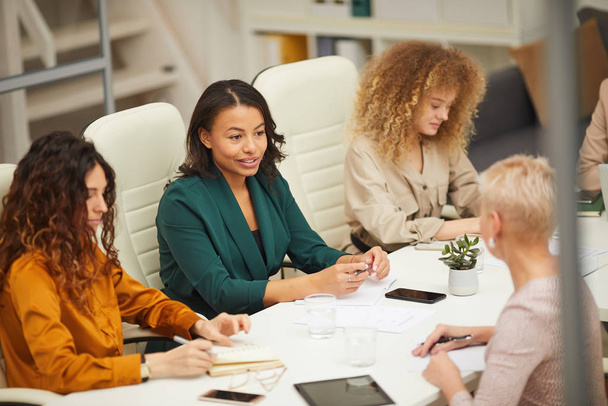 Group of businesswomen having meeting in modern office horizontal high angle shot - Photo, Image