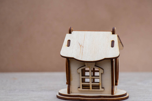 A small wooden house stands on a table - Fotoğraf, Görsel