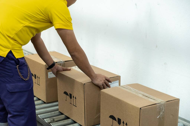 A yellow t-shirt man working in a warehouse. - Photo, image