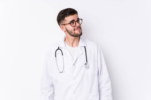 Young caucasian doctor man isolated dreaming of achieving goals and purposes - Photo, Image