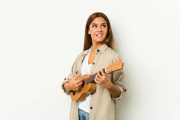 Young caucasian woman playing ukelele isolated - Foto, Imagem