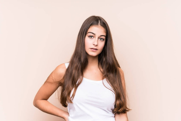 Young cute caucasian woman against a beige background - Valokuva, kuva