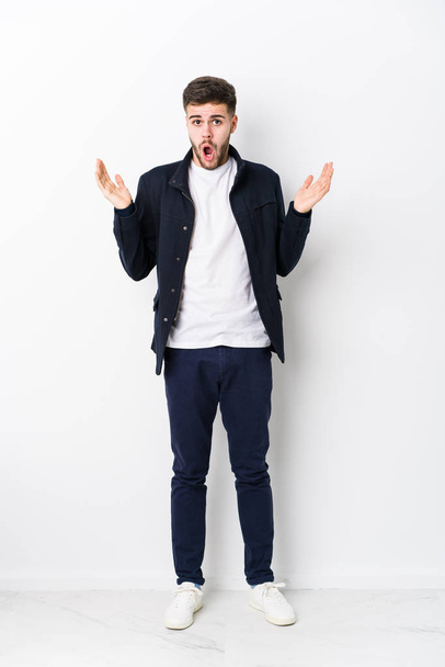 Full body young caucasian man isolated surprised and shocked. - Photo, Image