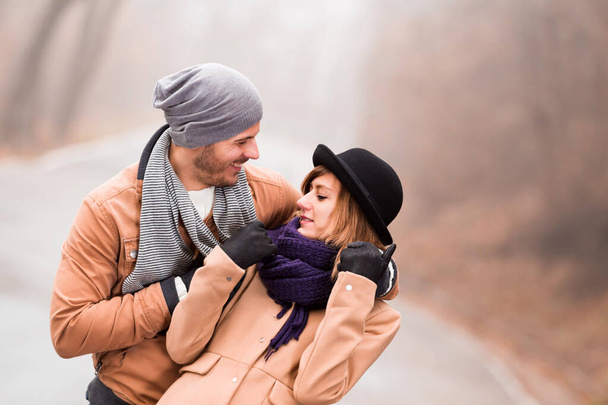 Couple enjoying outdoors in cold autumn / winter time. - Фото, зображення