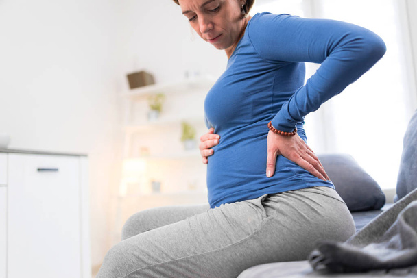Pregnant tired exhausted woman with stomach issues and back pain - Zdjęcie, obraz