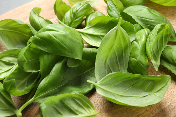 Fresh basil leaves on wooden table, closeup - Photo, Image