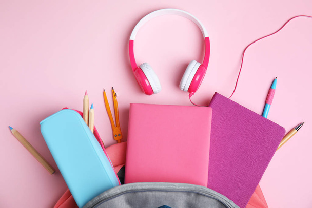 Flat lay composition with books and headphones on pink background - Foto, immagini