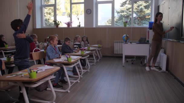 Kluger Schüler geht während des Unterrichts zur Tafel - Filmmaterial, Video
