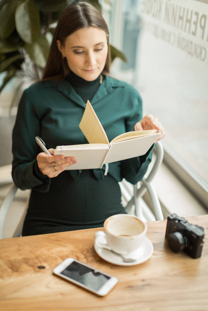 young woman in a meeting at breakfast with a notebook in the caf - Foto, Imagem