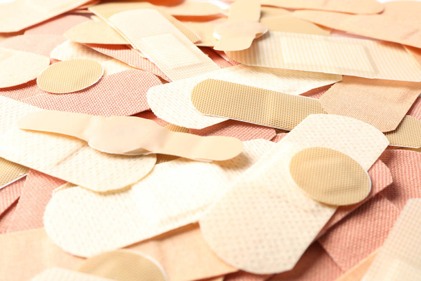 Different medical sticking plasters as background, closeup. First aid item - Foto, imagen