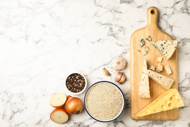 Flat lay composition with different ingredients on marble table, space for text. Risotto recipe - Foto, Imagen