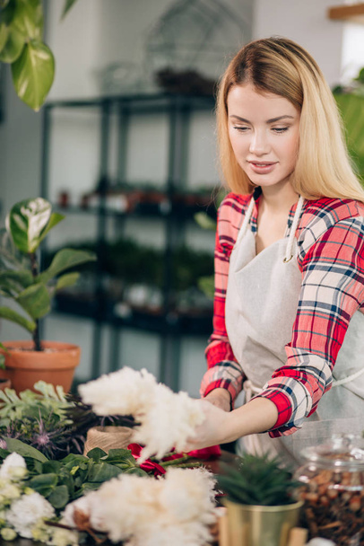 flowers lover, young florist woman look after and take care of plants - Valokuva, kuva