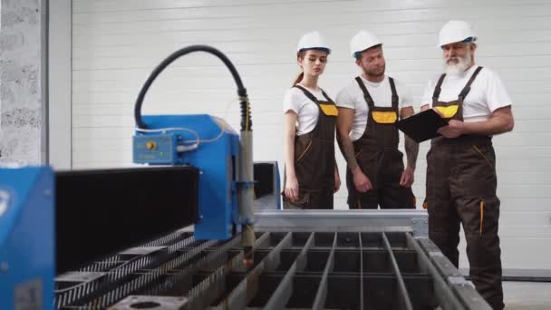Három mérnök ellenőrzi a plazmavágót.. - Felvétel, videó