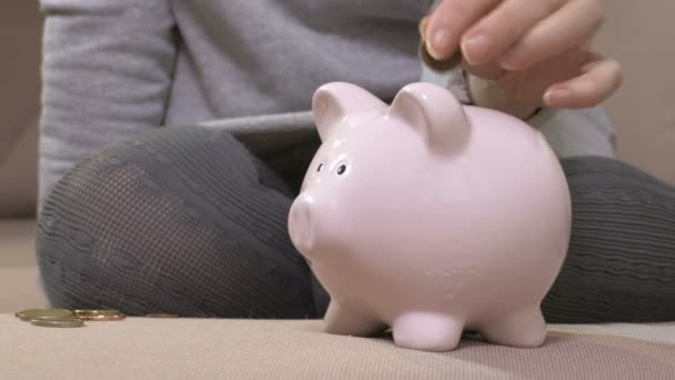 Frau legte ihre Ersparnisse in Sparschwein - Filmmaterial, Video