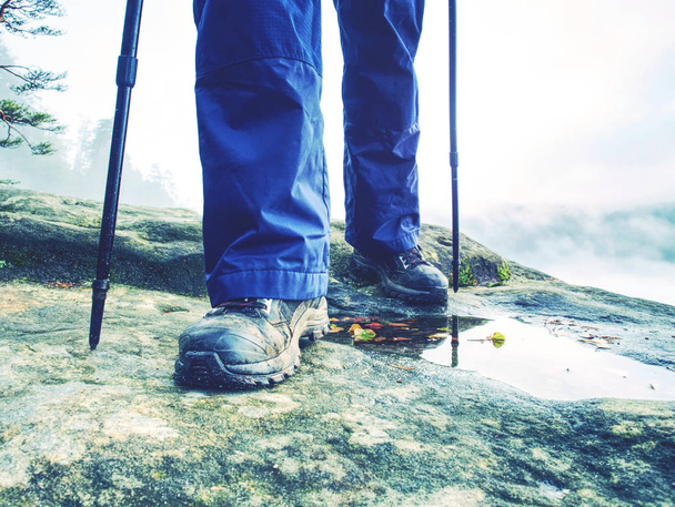 Hiker walks on Trail in warm trousers and waterproof boots - Fotoğraf, Görsel