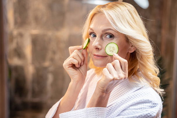 Modern lady moisturizing her skin at home - Foto, immagini