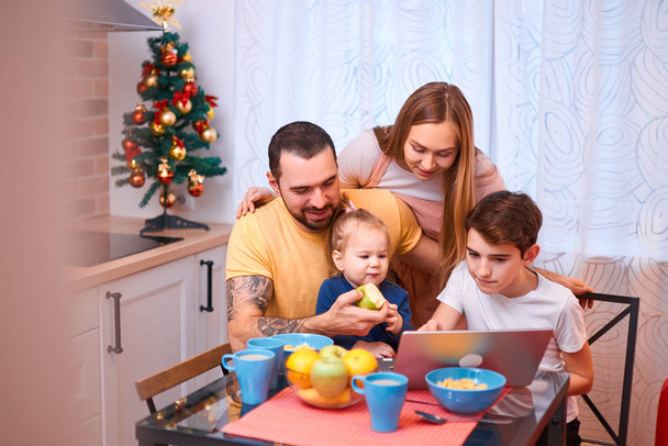 caucasian family watching film or video while having breakfast - Photo, Image