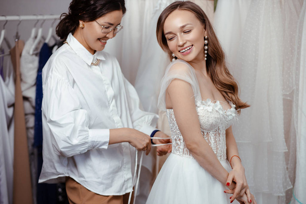 making dress in wedding salon - Photo, image