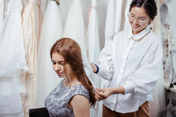 side view on positive designer and client in wedding salon - 写真・画像