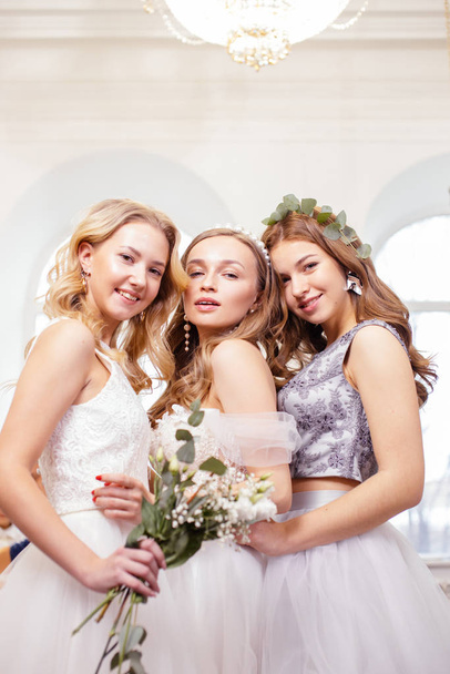 three caucasian girlfriends try on wedding dresses - Photo, Image