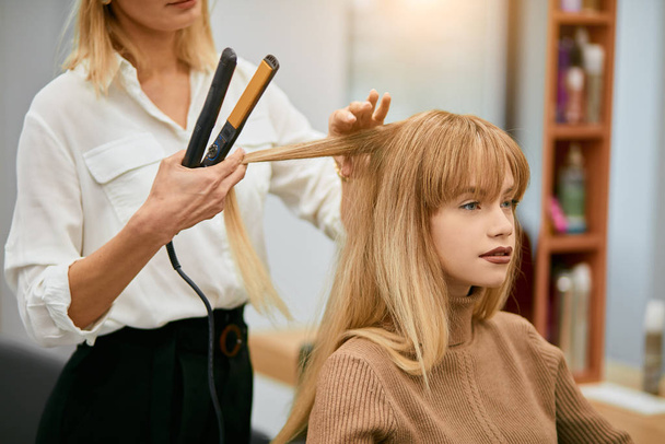 modern hairdresser doing her work in beauty saloon - Photo, image