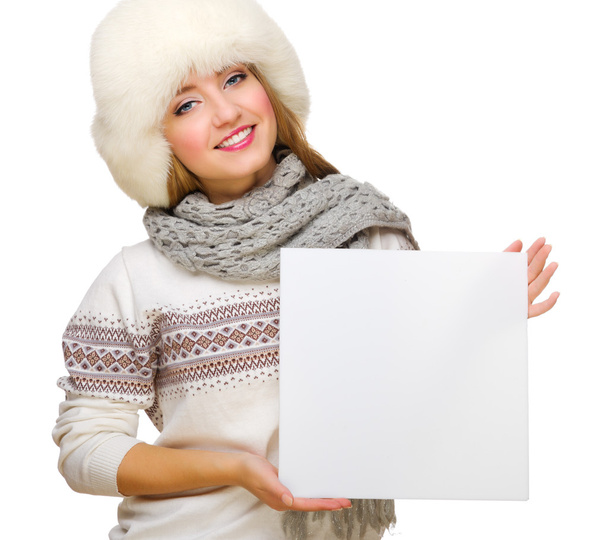 Young girl in fur hat with empty card - Foto, imagen