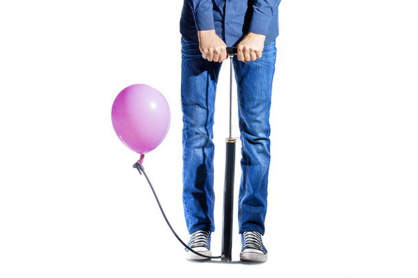 a man with a pump is pumping a balloon - Photo, Image