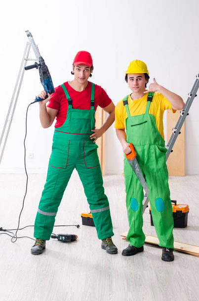Two workers contractors working indoors - Foto, Imagen